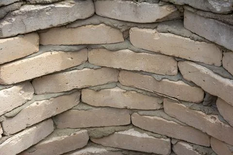 Brickwork in a semicircle of white, gray bricks. The wall of an old well. Grunge Stock Photos