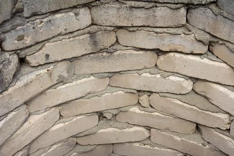 Brickwork in a semicircle of white, gray bricks. The wall of an old well. Grunge Stock Photos