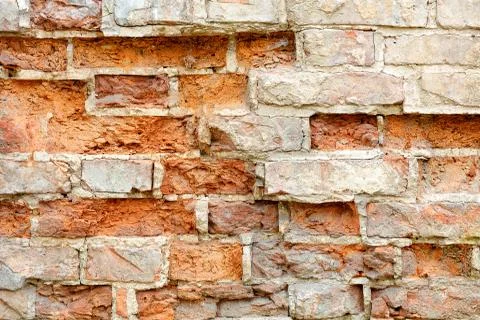 Brickwork texture of an old destroyed house, closeup, copy space. Stock Photos