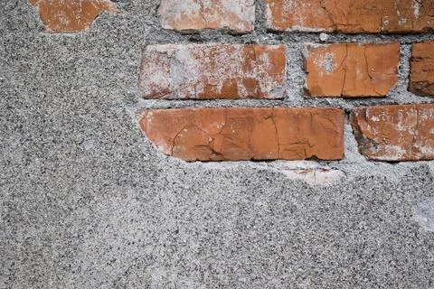 Brickwork under crumbling texture concrete surface. Close up Stock Photos