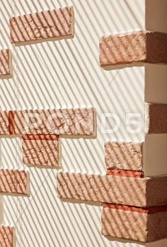 Brickwork wall striped by sunlight Stock Photos