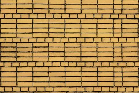Brickwork of yellow bricks on cement mortar. Stock Photos