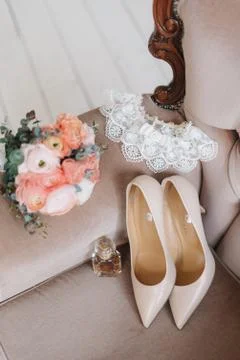 Bridal elements of an elegant classic wedding: a pair of classic beige high-h Stock Photos