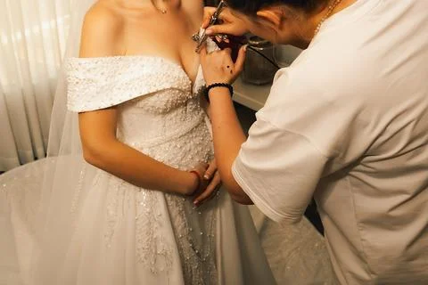 Bridal makeup application in  bright room during wedding preparation in a coz Stock Photos