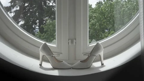 Bridal shoes at the window with waving trees outside Stock Footage 171326837