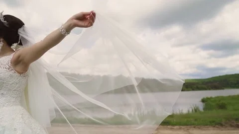 Bridal veil waving slow motion near forest lake Stock Footage 234086884