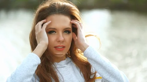 Bride adjust her volume elegant hair. Beauty's make up is magical and delectable Stock Footage 111669306