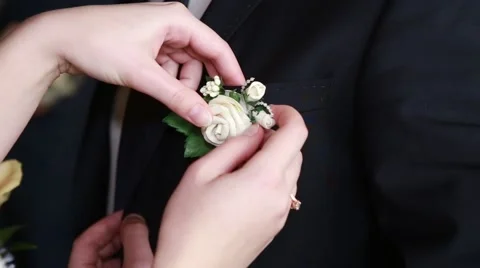 Bride adjusting flower on groom's jacket Stock-Footage 62796078