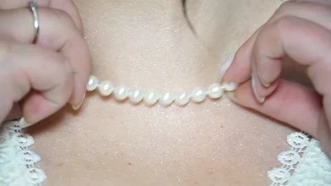 The bride adjusts the beads on her neck. Close-up shot of details of the bride's Stock Footage 238026411