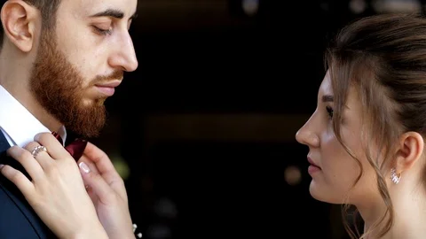 Bride adjusts groom bow-tie before wedding slow motion Stock Footage 119762589