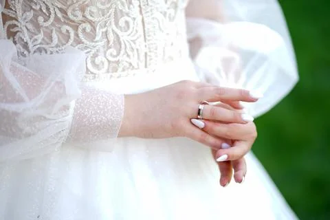 The bride adjusts the wedding ring on her finger. Wedding ceremony. Stock Photos