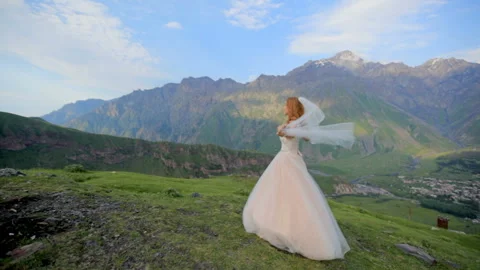 The bride is against a background of a stunning mountain landscape. Stock Footage 93027430