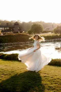 Bride against the background of a yellow sunset Stock Photos