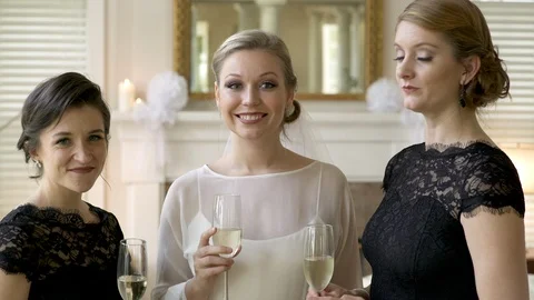 Bride and bridesmaids looking at camera smiling. Stock Footage 88160170