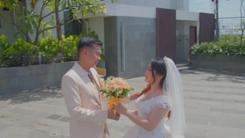 Bride and Groom Approaching Each Other with Bouquet in Outdoor Wedding Setting Video stock 333376161