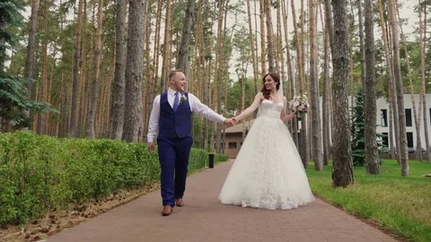 The bride and groom are walking in the park. Stock Footage 80108770