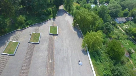 The bride and groom are walking in the park. Shooting from a quadrocopter. Stock Footage 85735951