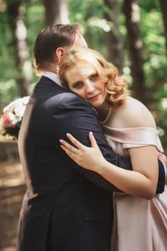 Bride and groom on the background of trees and forest sun Stock Photos