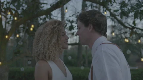 Bride and Groom in the Backyard with String Lights Kissing Stock Footage 208784643