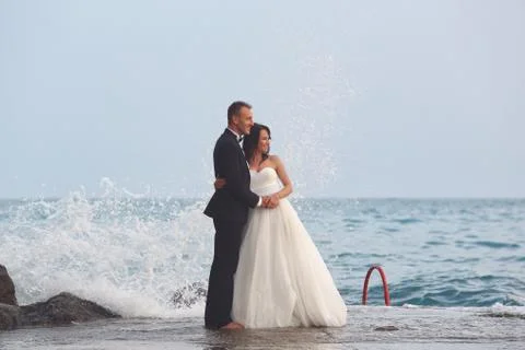 Bride and groom at the beach Stock Photos