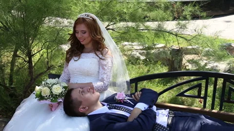 Bride and groom on the bench Stock Footage 68542905