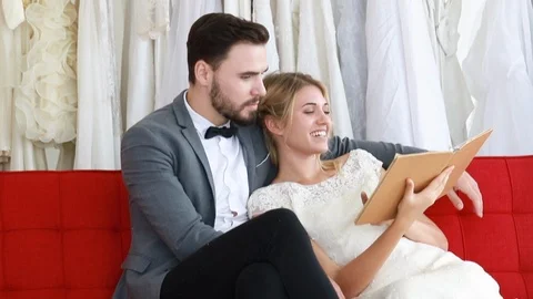 Bride and groom couple of Caucasian choosing dress in wedding studio. Stock Footage 102379341