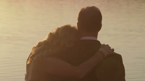 Bride and Groom Cuddle at Sunset Stock Footage 47679083