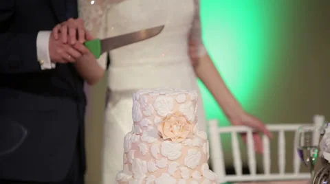 The bride and groom cut the wedding cake Stock Footage 44569952