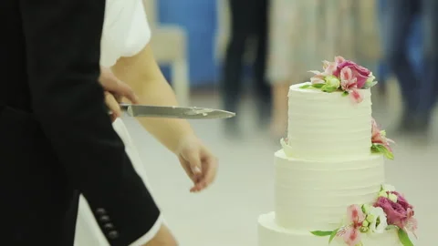 The bride and groom cut the wedding cake. Cut the wedding cake. Detail of Video stock 196003773