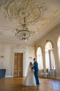 The bride and groom dance in an old estate, interior Stock Photos