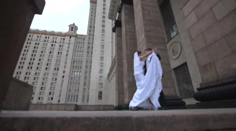 Bride and groom dancing on the background of the building on the street Stock Footage 61864788