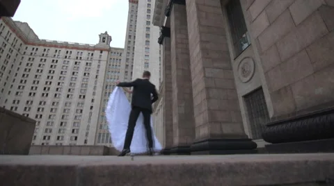 Bride and groom dancing on the background of the building Stock Footage 61887251