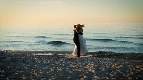 Bride and groom dancing on the beach Stock Footage 99504196