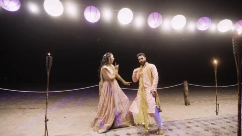 Bride And Groom Dancing During The Pre-Wedding Sangeet Function. Zoom In Stock Footage 219464331