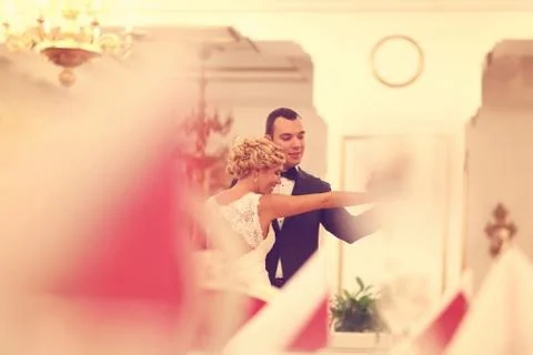 Bride and groom dancing in empty restaurant Stock Photos