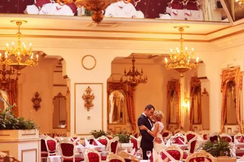 Bride and groom dancing in empty restaurant Foto stock