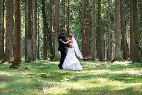 Bride and groom dancing in the forest 写真素材