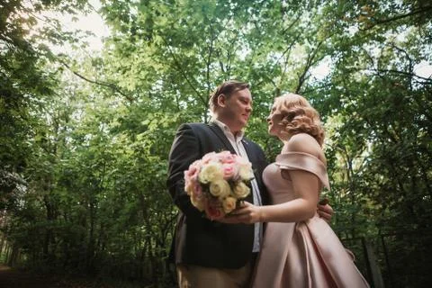 Bride and groom dancing in the forest background and sunlight Stock Photos