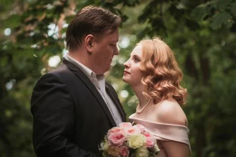 Bride and groom dancing in the forest background and sunlight Stock Photos