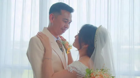 Bride and Groom Embracing Each Other with Loving Eye Contact on Wedding Day Видео 333375268