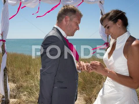 Bride and groom exchanging wedding rings Stock Photos