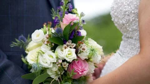 A bride and groom facing each other, holding a bouquet. Stock Footage 288710283