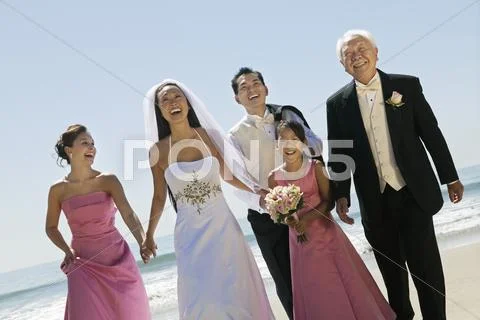 Bride and Groom with family on beach (portrait) Stock Photos