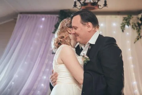 Bride and groom first dancing on background a restaurant Stock Photos