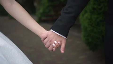 The bride and groom hold hands Stock Footage 168009800