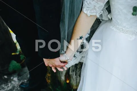 Bride and groom holding hand Stock Photos