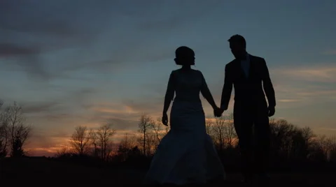 Bride and Groom Holding Hands and Kissing at Sunset 60FPS Stock Footage 65249553