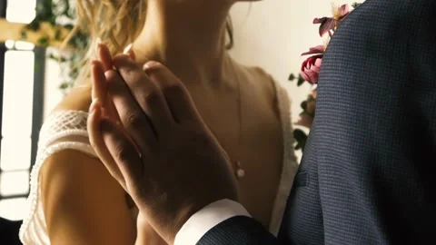 Bride and groom holding hands, touching each other tenderly Stock Footage 161867862