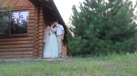 The bride and groom hugging near a wooden house Vídeo Stock 59182627