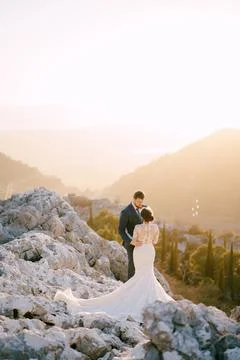 Bride and groom hugging on the top of the mountain 스톡 사진